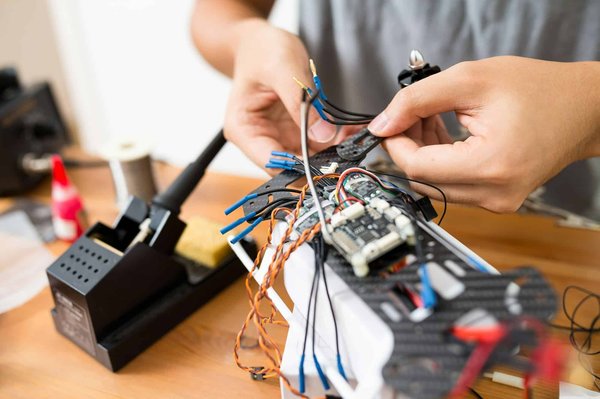 What are the key considerations for designing realistic flight dynamics in drone racing games?